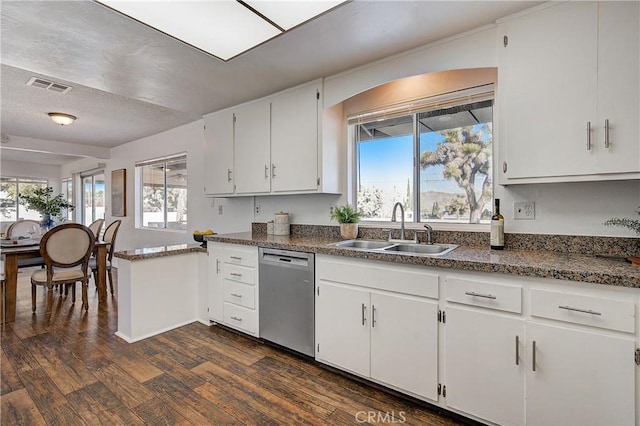 kitchen with stainless steel dishwasher, a textured ceiling, dark wood-type flooring, sink, and white cabinetry