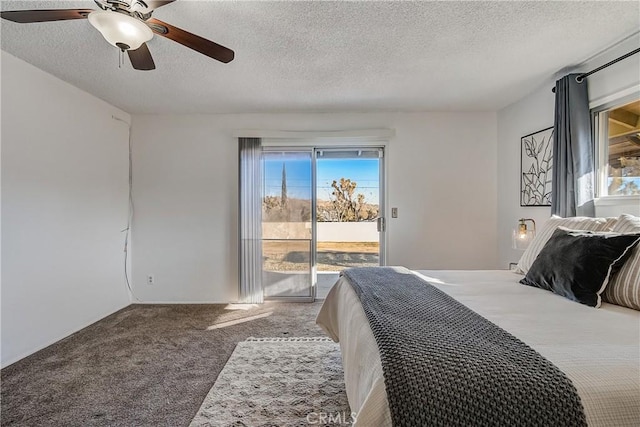 carpeted bedroom with a textured ceiling, access to exterior, ceiling fan, and multiple windows