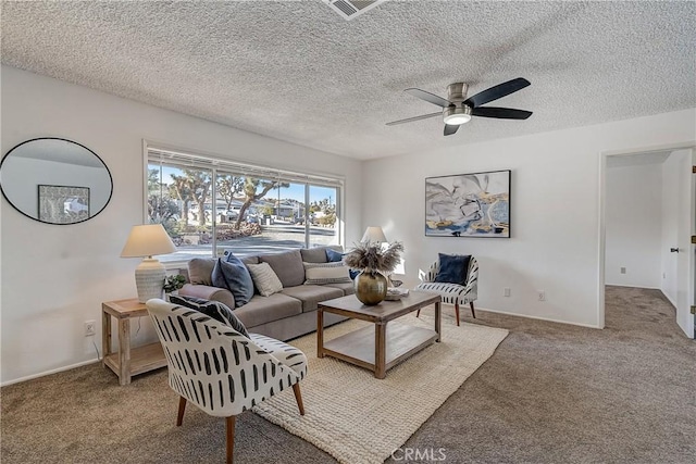 carpeted living room with ceiling fan and a textured ceiling