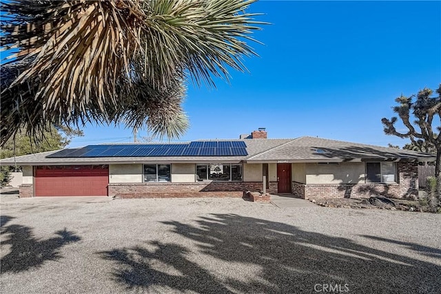 view of front of home with solar panels and a garage