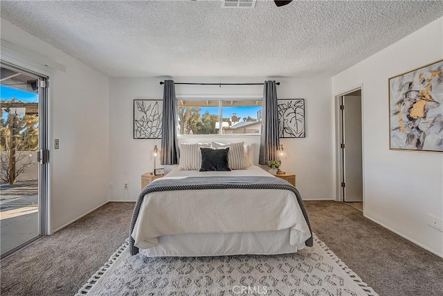 carpeted bedroom with access to exterior and a textured ceiling