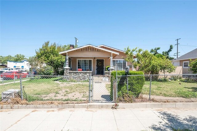 view of front of home featuring covered porch and a front yard