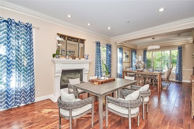 dining area with hardwood / wood-style flooring and crown molding