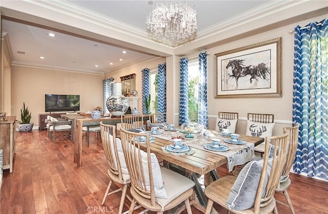 dining area featuring a notable chandelier, wood-type flooring, and crown molding