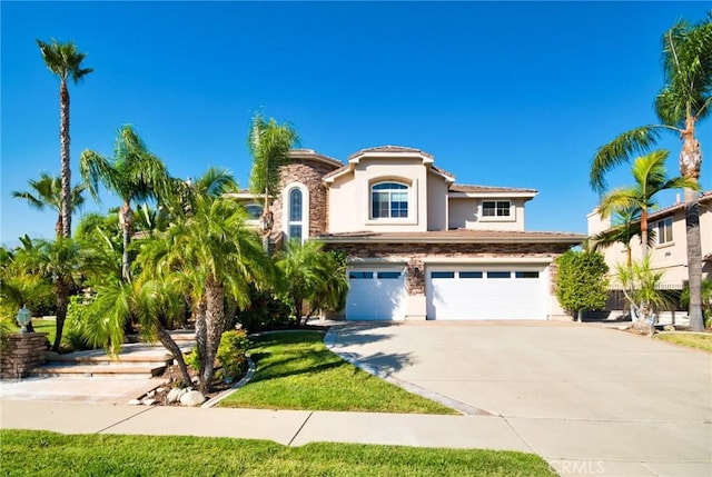 mediterranean / spanish home with a garage