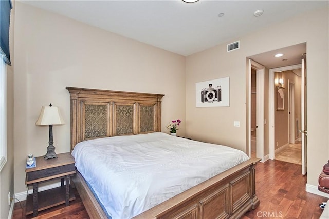 bedroom with dark hardwood / wood-style flooring