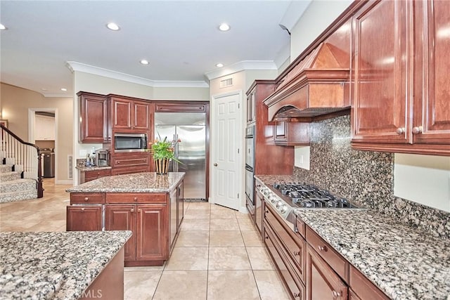 kitchen with appliances with stainless steel finishes, backsplash, light stone counters, ornamental molding, and light tile patterned floors