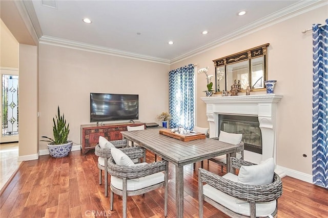 dining area featuring crown molding and hardwood / wood-style flooring