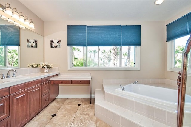 bathroom with a relaxing tiled tub and a healthy amount of sunlight