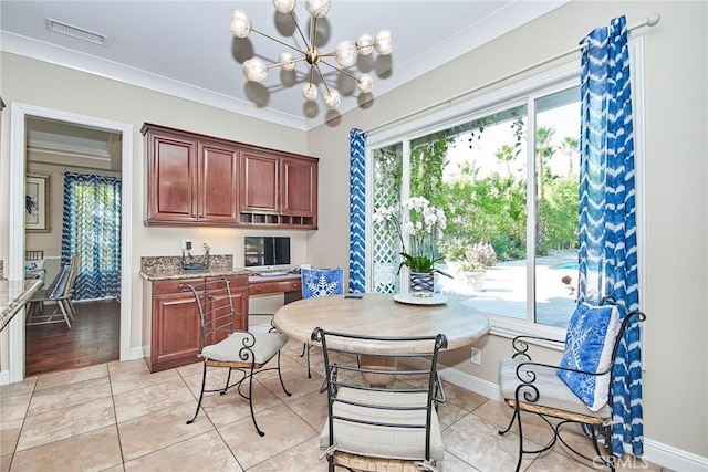 dining room with light tile patterned flooring, crown molding, and a notable chandelier