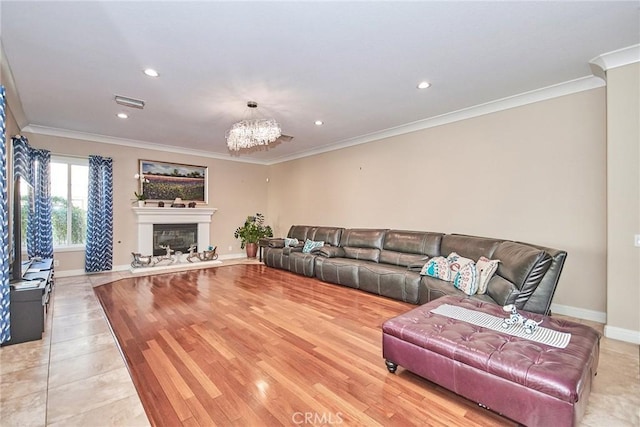 living room featuring an inviting chandelier, light hardwood / wood-style flooring, and ornamental molding