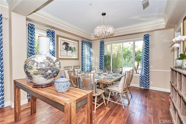 dining area with dark hardwood / wood-style flooring, a notable chandelier, and ornamental molding