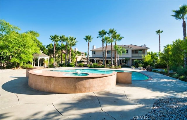 view of swimming pool with an in ground hot tub, a gazebo, and a patio