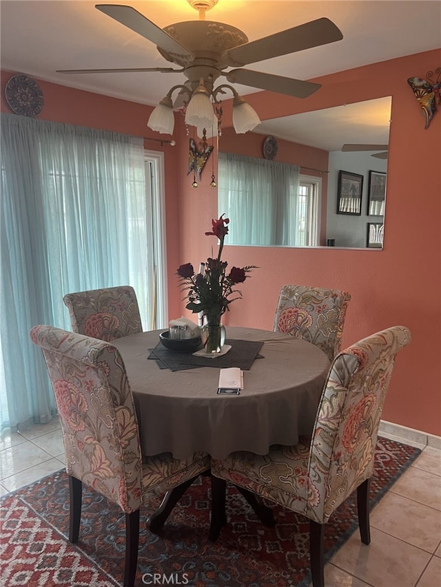 tiled dining space with a wealth of natural light and ceiling fan