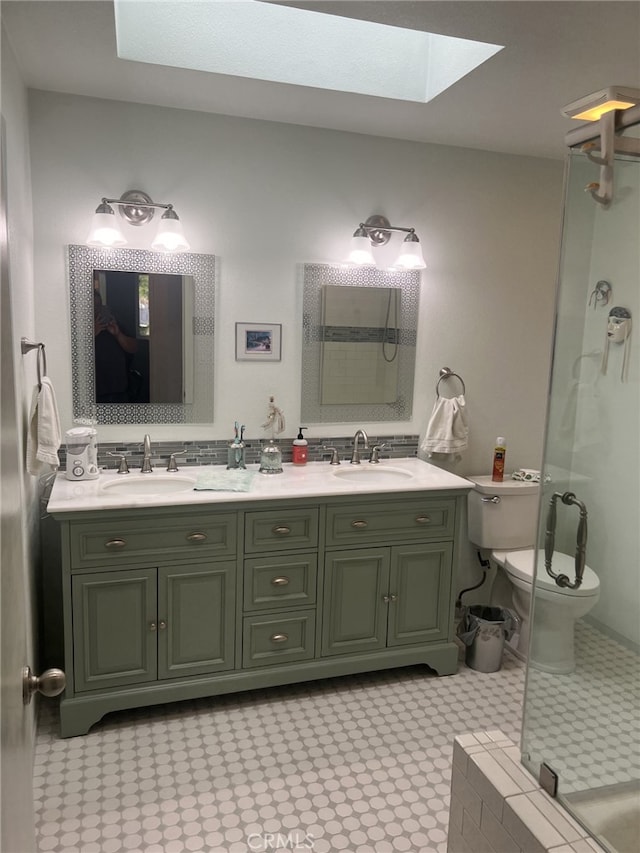 bathroom with vanity, toilet, walk in shower, and a skylight