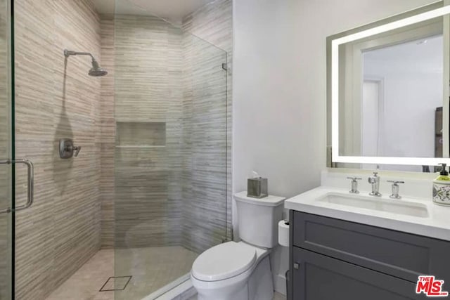 bathroom featuring walk in shower, vanity, and toilet