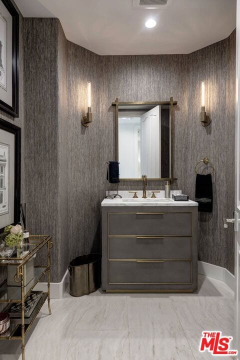 bathroom featuring tile flooring and vanity