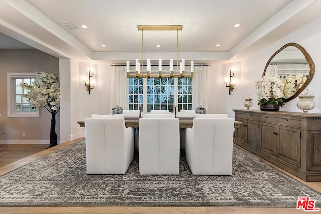 dining area featuring a notable chandelier and hardwood / wood-style flooring