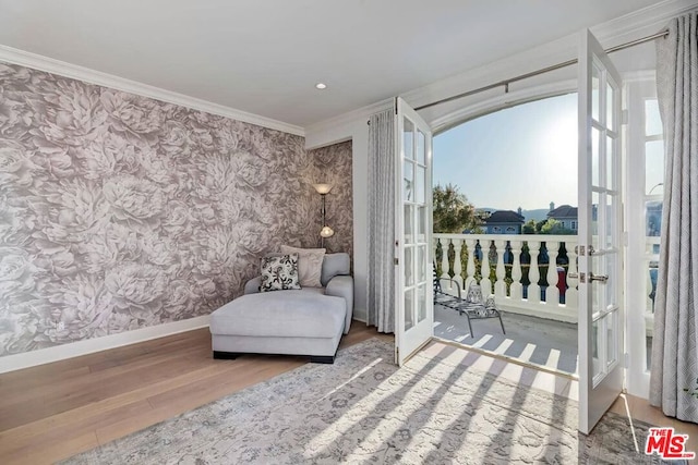 living area with ornamental molding, french doors, and wood-type flooring