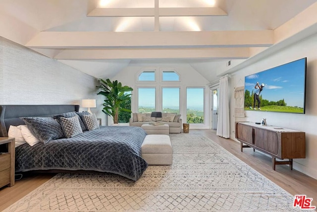 bedroom featuring vaulted ceiling with beams and wood-type flooring