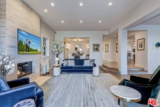 living room featuring hardwood / wood-style floors and a tiled fireplace