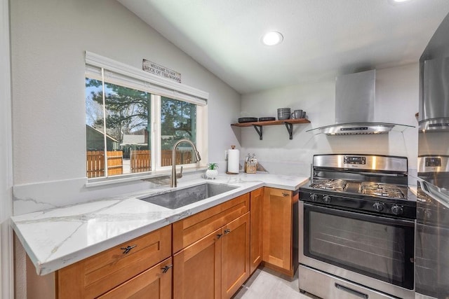 kitchen featuring light stone countertops, gas stove, vaulted ceiling, sink, and range hood