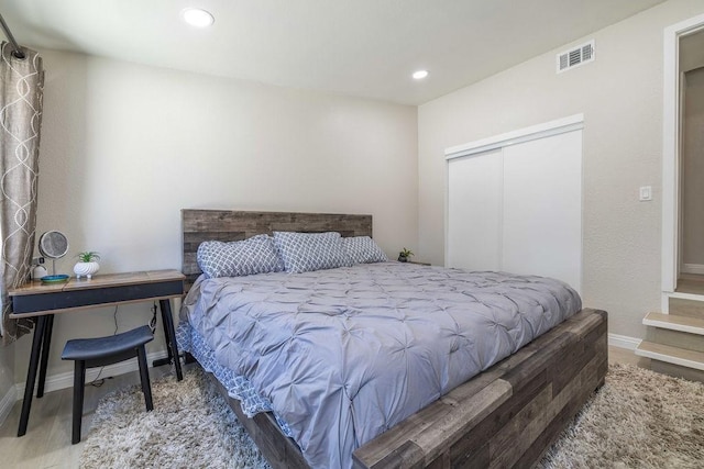 bedroom featuring wood-type flooring and a closet