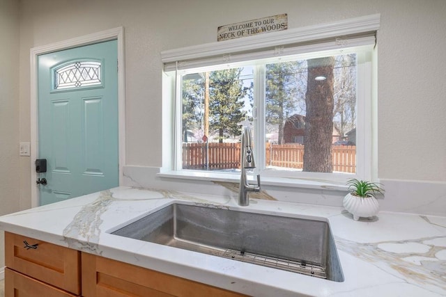 room details with light stone countertops and sink