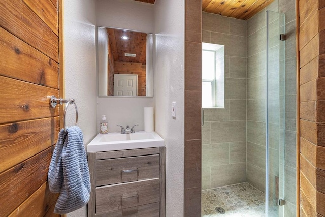 bathroom with wooden ceiling, vanity, and a shower with shower door