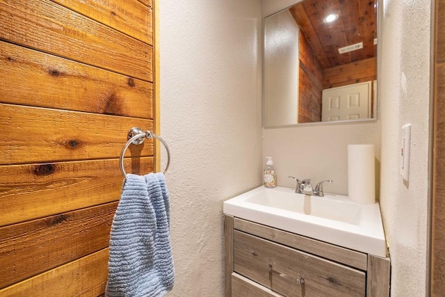 bathroom featuring vanity and wood ceiling