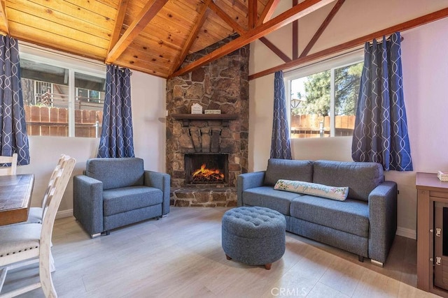 living room featuring beam ceiling, high vaulted ceiling, wooden ceiling, hardwood / wood-style floors, and a stone fireplace