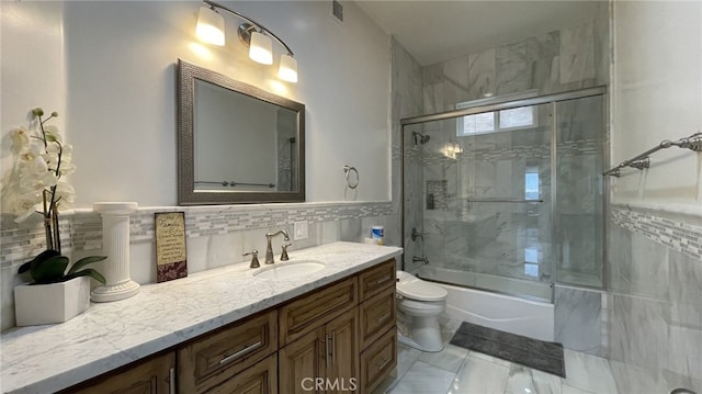 full bathroom with shower / bath combination with glass door, tasteful backsplash, toilet, tile floors, and large vanity