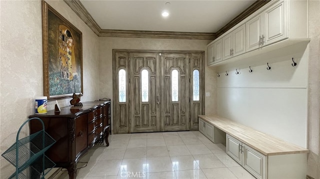 mudroom featuring ornamental molding and light tile floors