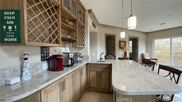 kitchen featuring decorative light fixtures, kitchen peninsula, crown molding, sink, and light tile floors