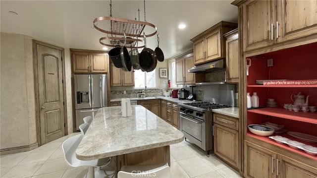 kitchen featuring light tile flooring, stainless steel appliances, backsplash, a center island, and sink