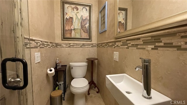 bathroom with tile floors, sink, and toilet