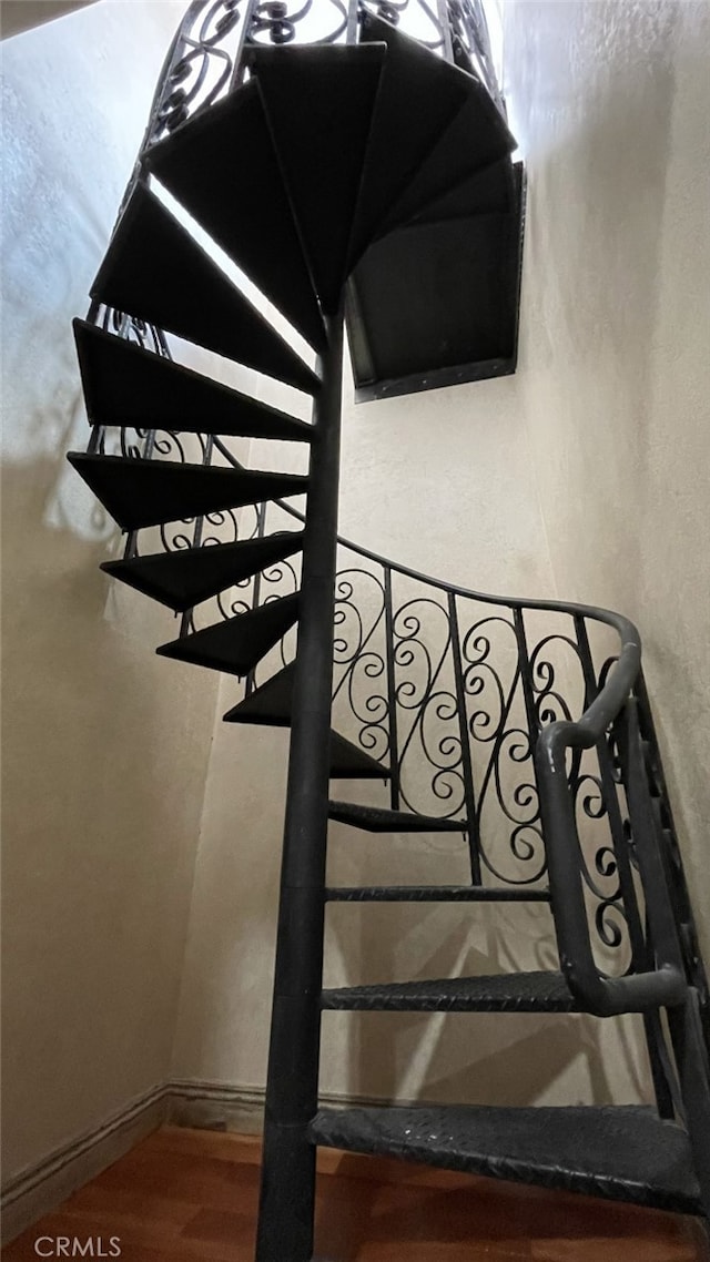 stairway featuring hardwood / wood-style flooring