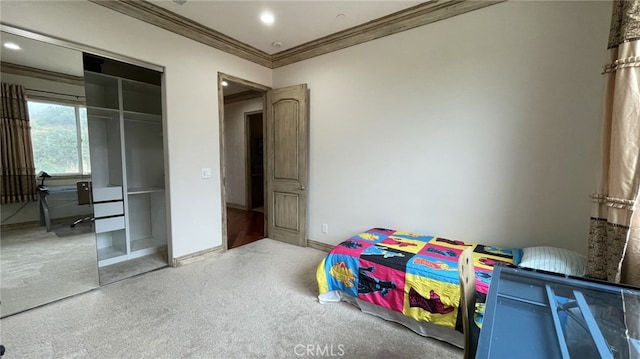 bedroom featuring ornamental molding, a closet, and hardwood / wood-style flooring