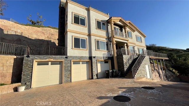 view of front of house with a garage and a balcony