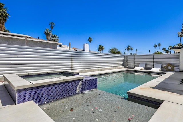 view of pool featuring an in ground hot tub