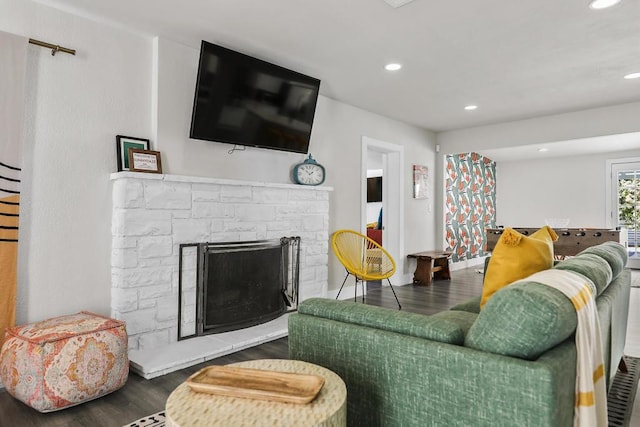 living room featuring a fireplace and dark hardwood / wood-style floors