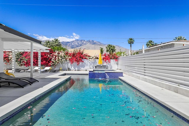 view of pool featuring a mountain view, an in ground hot tub, and a patio