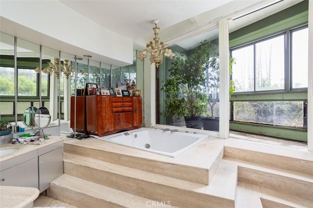 bathroom with vanity and tiled bath