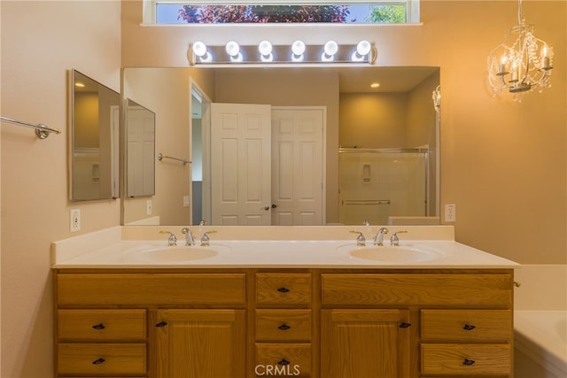 bathroom featuring separate shower and tub, vanity, and a notable chandelier