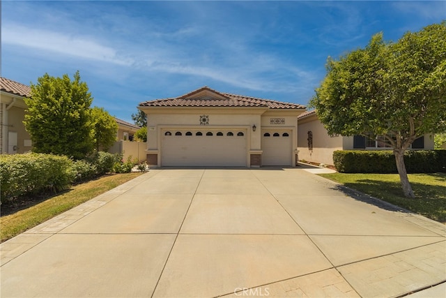 mediterranean / spanish house with a garage