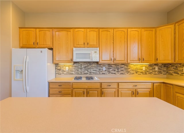 kitchen with white appliances and backsplash