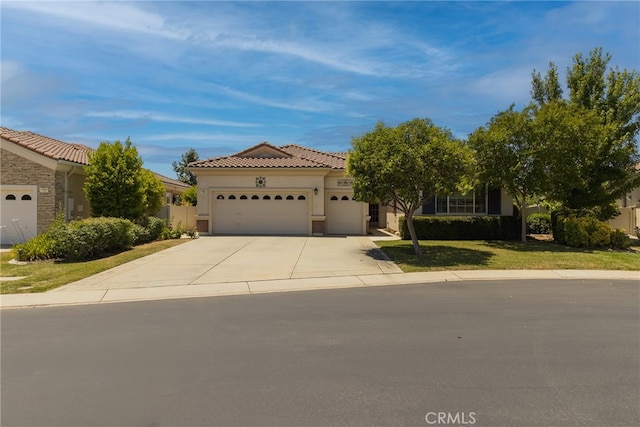 view of front of property with a front yard and a garage