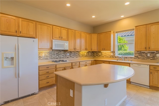 kitchen with backsplash, a center island, white appliances, and sink