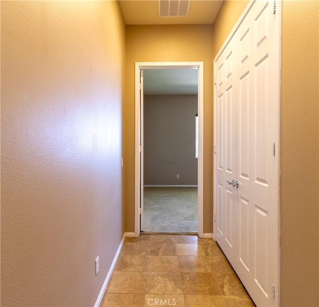 hallway featuring light tile patterned flooring