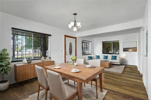 dining room with a chandelier and dark hardwood / wood-style floors